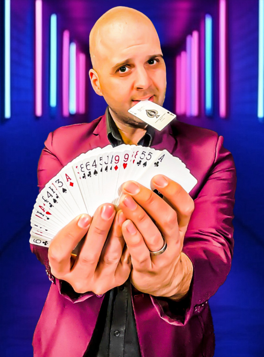 Michael Bourada performing with playing cards